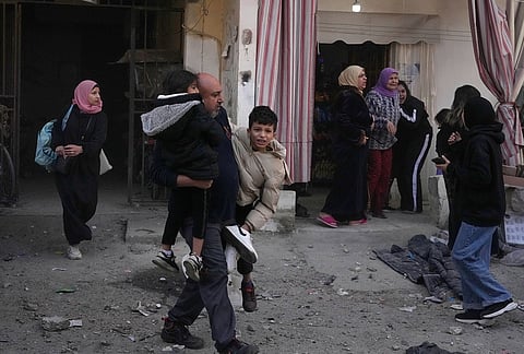 Residents flee the site of an Israeli airstrike that hit an apartment building in the southern port city of Sidon, Lebanon, Friday, March 13, 2026. 
