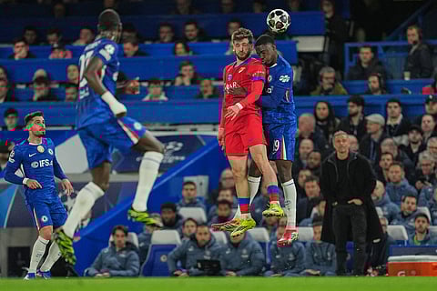 Chelsea's Mamadou Sarr, right, in action against PSG's Khvicha Kvaratskhelia during the Champions League soccer match between Chelsea and Paris Saint-Germain in London, England.