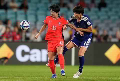 Japan's Saki Kumagai, right, and South Korea's Jeon Yu-gyeong battle for the ballduring the Women's Asian Cup semifinal soccer match between Japan and South Korea in Sydney.