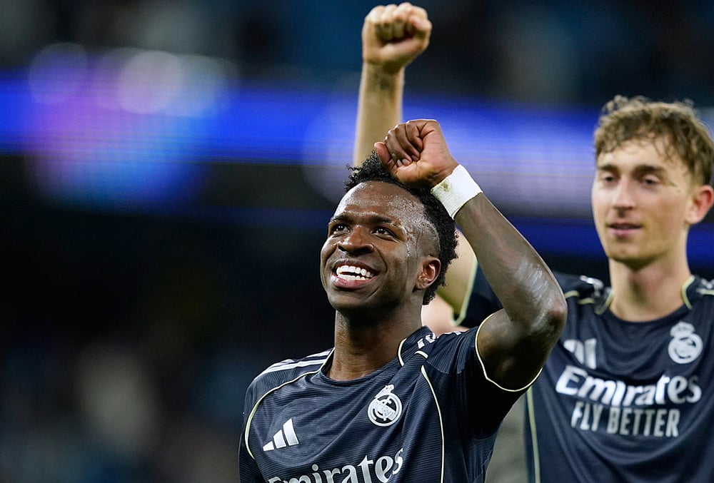 Real Madrid's Vinicius Junior celebrates after the Champions League round of 16 second leg soccer match between Manchester City and Real Madrid in Manchester. - | Photo: AP/Dave Thompson