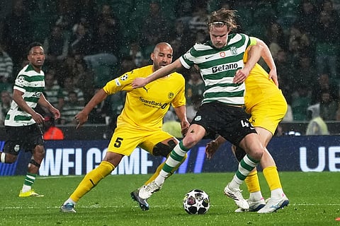 Sporting's Morten Hjulmand, center right, is challenged by Glimt's Haitam Aleesami during a Champions League round of 16 second leg soccer match between Sporting CP and Bodo Glimt in Lisbon, Portugal.