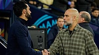 Man City Vs Real Madrid, UEFA Champions League: Guardiola Jokes ‘Everybody Wants To Fire Me’ After 5‑1 Aggregate Defeat | Photo: AP/Dave Thompson : Real Madrid's head coach Alvaro Arbeloa shakes hands with Manchester City's head coach Pep Guardiola ahead of the Champions League round of 16 second leg soccer match between Manchester City and Real Madrid in Manchester, Tuesday, March 17, 2026.