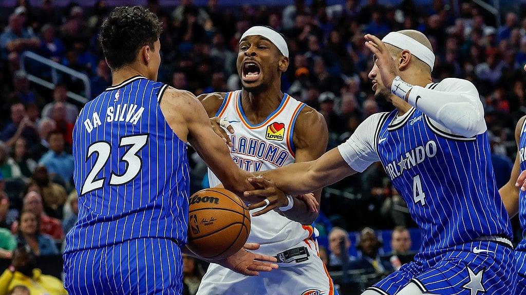 Oklahoma City Thunder guard Shai Gilgeous-Alexander, centre, has ball stripped away by Orlando Magic forward Tristan da Silva (23) and guard Jalen Suggs (4) during the second half of their NBA basketball game. - AP