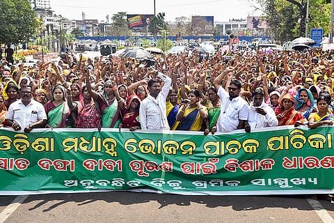 Members of the Nikhila Odisha Mid-Day Meal (MDM) Workers Association stage a demonstration outside the Odisha Legislative Assembly under the Biju Sramika Samukhya (BSS) banner during the Budget Session, pressing their seven-point charter of demands, in Bhubaneswar.