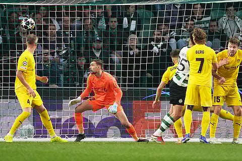 Sporting's Goncalo Inacio, third right, scores his side's opening goal during a Champions League round of 16 second leg soccer match between Sporting CP and Bodo Glimt in Lisbon, Portugal.