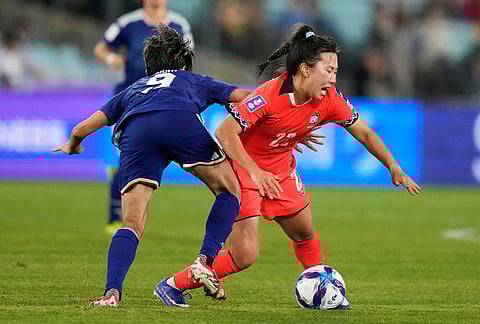 South Korea's Choo Hyo-joo, right, and Japan's Riko Ueki battle for the ball during the Women's Asian Cup semifinal soccer match between Japan and South Korea in Sydney.