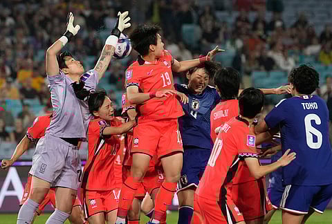 South Korea's goalkeeper Kim Min-jung punches the ball during the Women's Asian Cup semifinal soccer match between Japan and South Korea in Sydney.