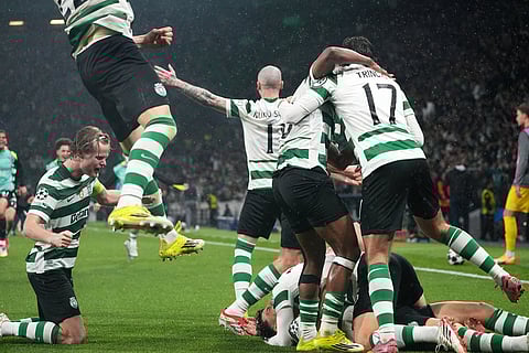 Sporting CP players celebrate after Sporting's Maximiliano Araujo scored his side's fourth goal during a Champions League round of 16 second leg soccer match between Sporting CP and Bodo Glimt in Lisbon, Portugal.