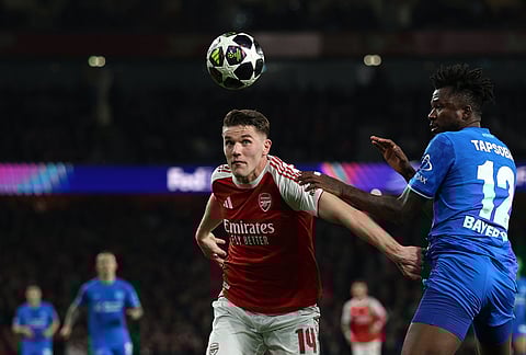 Arsenal's Viktor Gyoekeres, left, and Leverkusen's Edmond Tapsoba challenge for the ball during the second leg of the Champions League round of 16 soccer match between Arsenal and Bayer Leverkusen, in London.