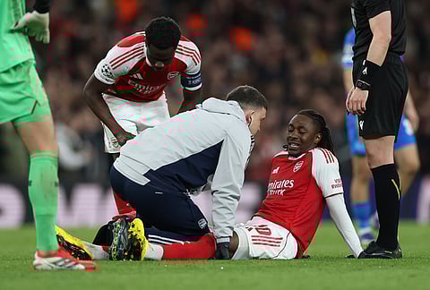 Arsenal's Eberechi Eze receives medical treatment after sustaining an injury during the second leg of the Champions League round of 16 soccer match between Arsenal and Bayer Leverkusen, in London.
