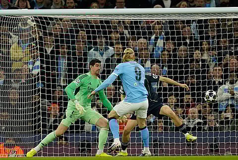 Manchester City's Erling Haaland scores his side's first goal during the Champions League round of 16 second leg soccer match between Manchester City and Real Madrid in Manchester.