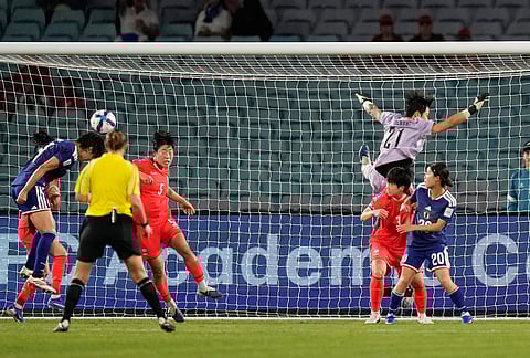 Japan's Saki Kumagai, left, heads the ball to score her team's third goal during the Women's Asian Cup semifinal soccer match between Japan and South Korea in Sydney.