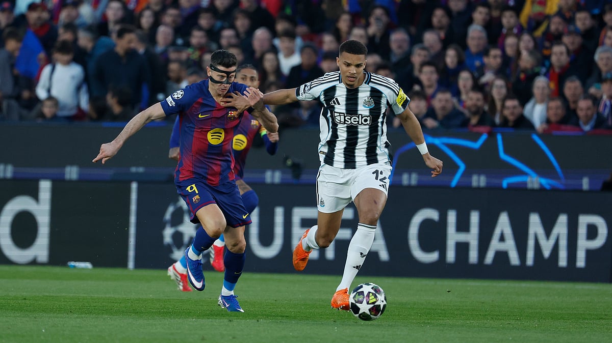 Newcastle's Malick Thiaw, right, and Barcelona's Robert Lewandowski fight for the ball during the Champions League round of 16, second leg soccer match. - AP
