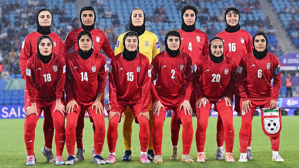 Iran players pose for a team photo ahead of the Women's Asian Cup match between Iran and the Philippines in Robina, Australia. - Dave Hunt/AAPImage via AP, File