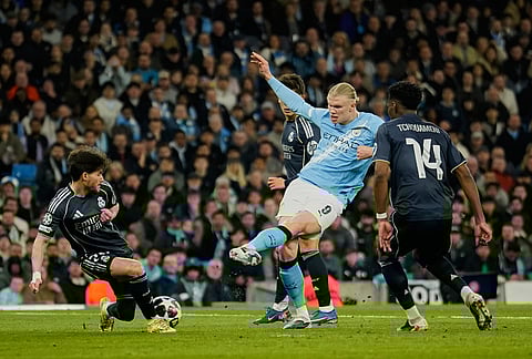 Real Madrid's Fran Garcia blocks a ball kicked by Manchester City's Erling Haaland during the Champions League round of 16 second leg soccer match between Manchester City and Real Madrid in Manchester.