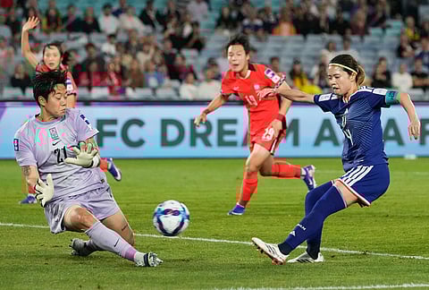 Japan's Yui Hasegawa, right, has her shot at goal saved by South Korea's goalkeeper Kim Min-jung, left, during the Women's Asian Cup semifinal soccer match between Japan and South Korea in Sydney.