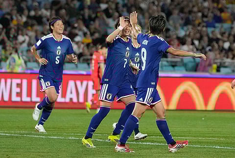 Japan's Riko Ueki, right, is congratulated by teammates after scoring her team's first goal during the Women's Asian Cup semifinal soccer match between Japan and South Korea in Sydney.