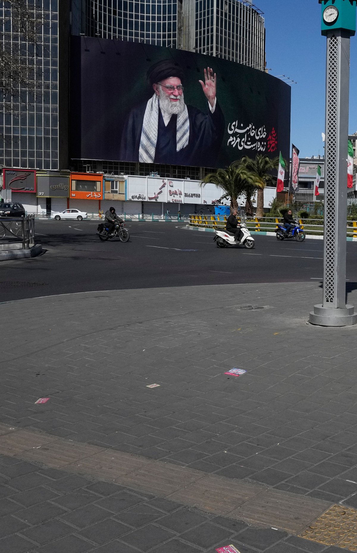 AP :  A woman crosses almost deserted square with a billboard at rear showing a portrait of the late Iranian Supreme Leader Ayatollah Ali Khamenei, who was killed in the U.S.–Israeli military campaign, in Tehran, Iran, Tuesday, March 3, 2026. (AP Photo/Vahid Salemi)