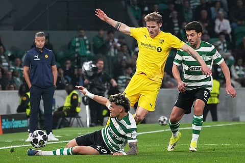 Glimt's Ole Didrik Blomberg is tackled by Sporting's Maximiliano Araujo during a Champions League round of 16 second leg soccer match between Sporting CP and Bodo Glimt in Lisbon, Portugal.