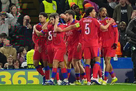 Paris Saint-Germain players celebrate after PSG's Bradley Barcola scored his side's second goal during the Champions League soccer match between Chelsea and Paris Saint-Germain in London, England.