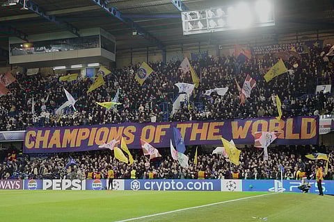 Chelsea fans display a banner reads "Champions of the World" during the Champions League soccer match between Chelsea and Paris Saint-Germain in London, England.