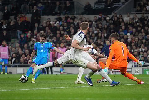 Atletico Madrid's Julian Alvarez, left, shoots the ball during the Champions League round of 16, second leg soccer match between Tottenham and Atletico Madrid in London, England.