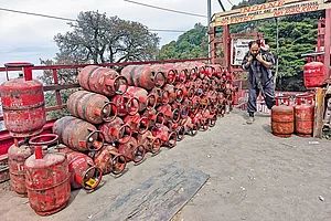 | Photo: Imago : In the Hills: A worker carries an LPG cylinder for distribution in Shimla, Himachal Pradesh