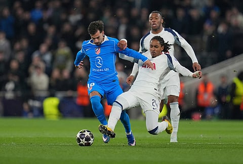 Atletico Madrid's Alex Baena, left, and Tottenham's Djed Spence challenge for the ball during the Champions League round of 16, second leg soccer match between Tottenham and Atletico Madrid in London, England.