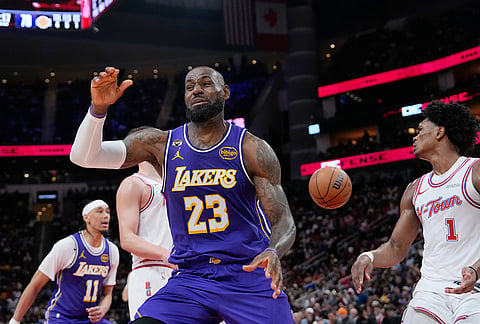 Los Angeles Lakers' LeBron James (23) reacts after a dunk against the Houston Rockets during the second half of an NBA basketball game in Houston. 