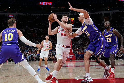 Houston Rockets' Alperen Sengun (28) drives to the basket as Los Angeles Lakers' Jaxson Hayes (11) defends during the first half of an NBA basketball game in Houston. 