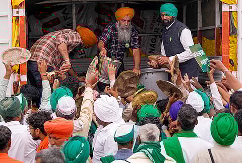 Farmers being offered a meal during a 'Kisan Panchayat' organised by the Samyukt Kisan Morcha to press for various demands, at Ramlila Maidan, in New Delhi.