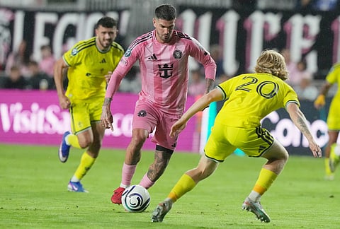 Inter Miami midfielder Rodrigo de Paul runs with the ball as Nashville midfielder Edvard Tagseth (20) defends during the second half of a CONCACAF Champions Cup Round of 16 soccer match, in Fort Lauderdale, Florida.