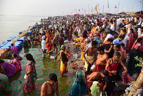 People gather to perform rituals near the Ganga river on the first day of the 'Navaratri' festival, in Prayagraj.