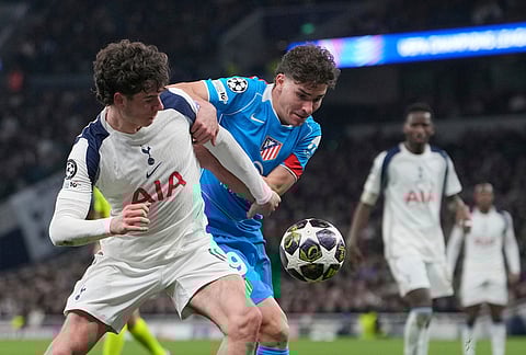 Atletico Madrid's Julian Alvarez, centre, and Tottenham's Archie Gray challenge for the ball during the Champions League round of 16, second leg soccer match between Tottenham and Atletico Madrid in London, England.