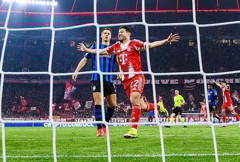 Bayern Munich's Raphaël Guerreiro celebrates after Lennart Karl scores to make it 3-0 against Atalanta Bergamo, in Munich, Germany.