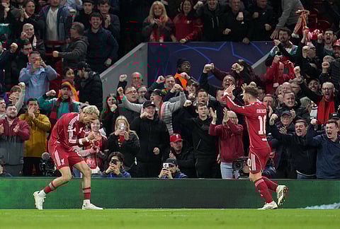 Liverpool's Hugo Ekitike, left, celebrates after scoring his side's second goal during the second leg of the Champions League round of 16 soccer match between Liverpool and Galatasaray, in Liverpool, England.