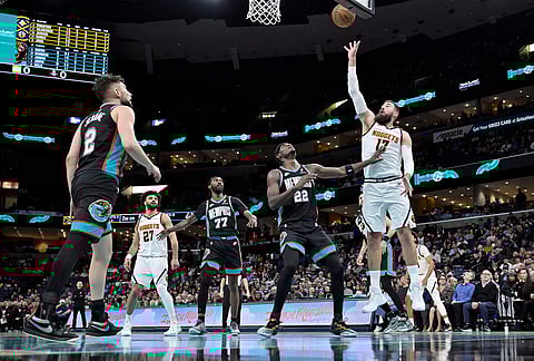 Denver Nuggets center Jonas Valanciunas (17) shoots against Memphis Grizzlies forward Taylor Hendricks (22) in the first half of an NBA basketball game in Memphis, Tennessee.