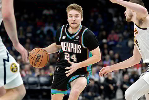 Memphis Grizzlies guard Cam Spencer (24) handles the ball against the Denver Nuggets in the second half of an NBA basketball game in Memphis, Tennessee.