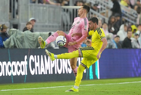 Nashville defender Daniel Lovitz and Inter Miami forward Tadeo Allende go after the ball during the first half of a CONCACAF Champions Cup Round of 16 soccer match, in Fort Lauderdale, Florida.