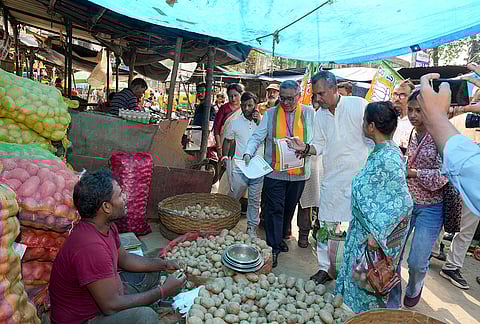 BJP candidate Swapan Dasgupta campaigns for the Rashbehari Assembly constituency at a local market ahead of the state Assembly elections, in Kolkata, West Bengal.