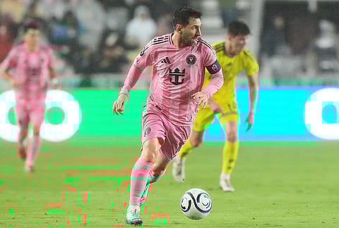 Inter Miami forward Lionel Messi (10) runs with the ball during the first half of a CONCACAF Champions Cup Round of 16 soccer match against Nashville, in Fort Lauderdale, Florida.