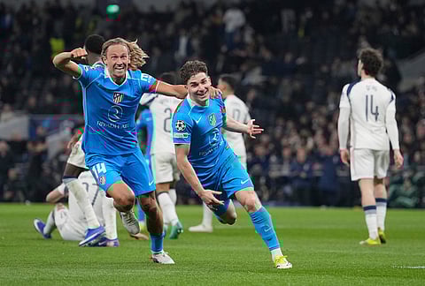 Atletico Madrid's Julian Alvarez, centre, celebrates with Atletico Madrid's Marcos Llorente after scoring his side's first goal during the Champions League round of 16, second leg soccer match between Tottenham and Atletico Madrid in London, England.