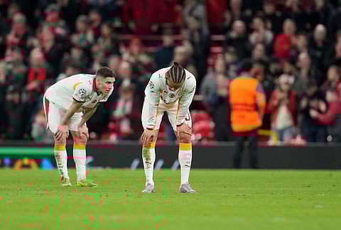 Galatasaray players react at the end of the second leg of the Champions League round of 16 soccer match between Liverpool and Galatasaray, in Liverpool, England.