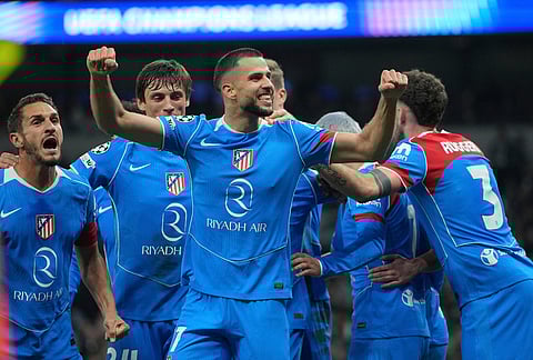 Atletico Madrid's David Hancko, centre, celebrates with teammates after scoring his side's second goal during the Champions League round of 16, second leg soccer match between Tottenham and Atletico Madrid in London, England.