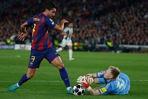 Newcastle's goalkeeper Aaron Ramsdale, bottom, saves a ball after Barcelona's Ferran Torres attempt to score during the Champions League round of 16, second leg soccer match between FC Barcelona and Newcastle United FC in Barcelona, Spain.
