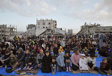 Palestinian Muslims gather for Eid al-Fitr prayers amid the rubble of destroyed buildings in Jabaliya, Gaza Strip, Friday, March 20, 2026. 