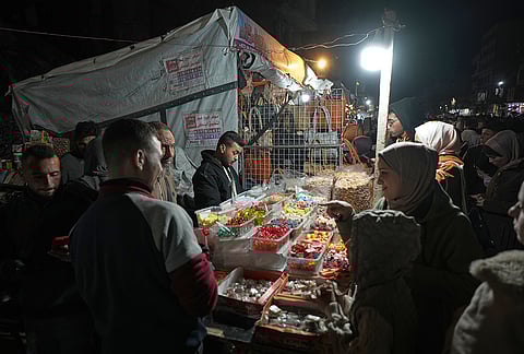 Palestinians shop at a market for Eid al-Fitr celebrations, in Gaza City, Thursday, March 19, 2026. 