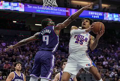 Philadelphia 76ers forward Dominick Barlow (25) goes for a layup against Sacramento Kings forward Precious Achiuwa (9) during the first half of an NBA basketball game, in Sacramento, California.