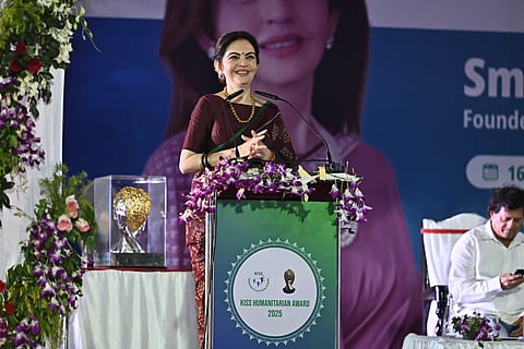 Nita Ambani smiling while addressing the audience at the KISS Humanitarian Award 2025