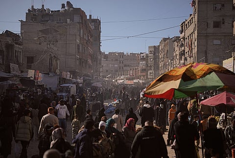 Palestinians shop at a market in preparation for Eid al-Fitr in Khan Younis, southern Gaza Strip, Tuesday. March 17, 2026. 